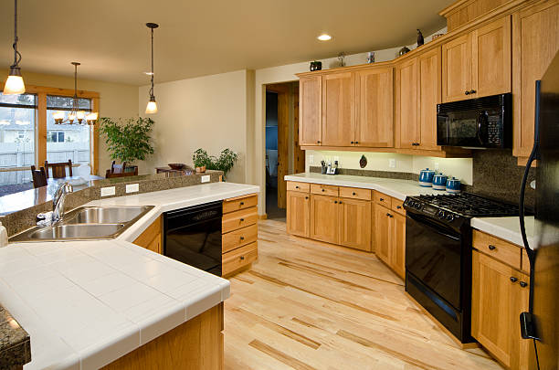 This modern kitchen has hardwood cabinets and floor. | CA
